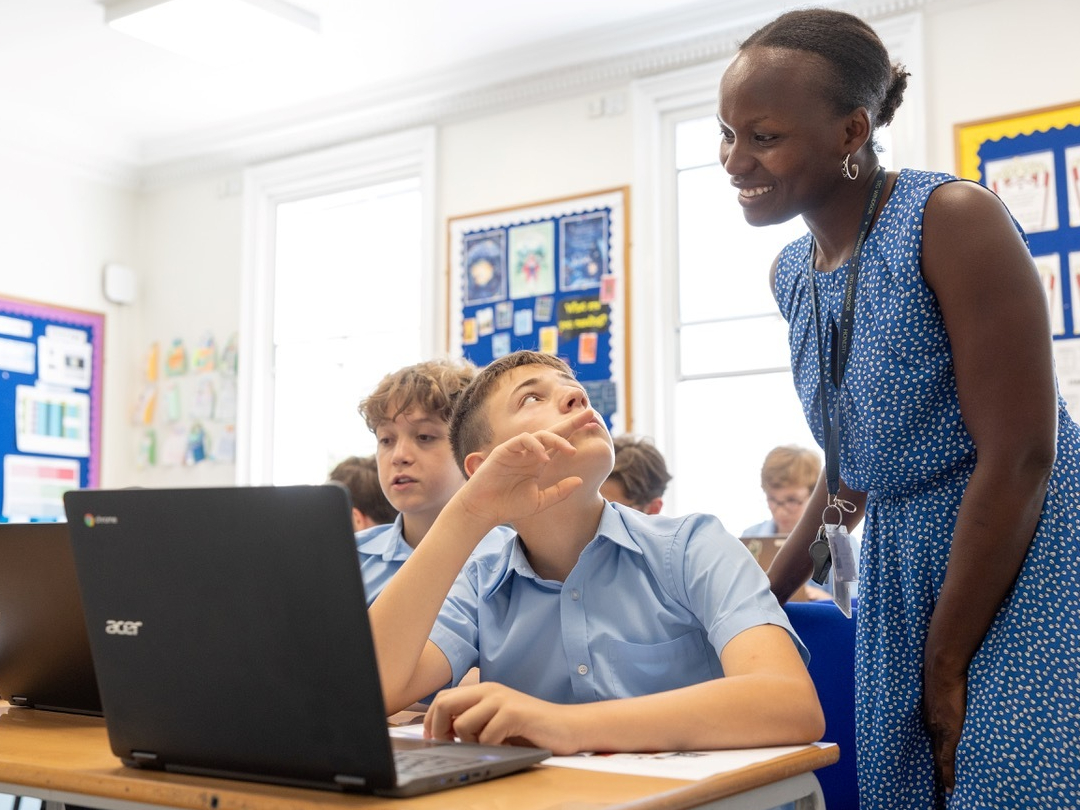 Teacher helping student in classroom
